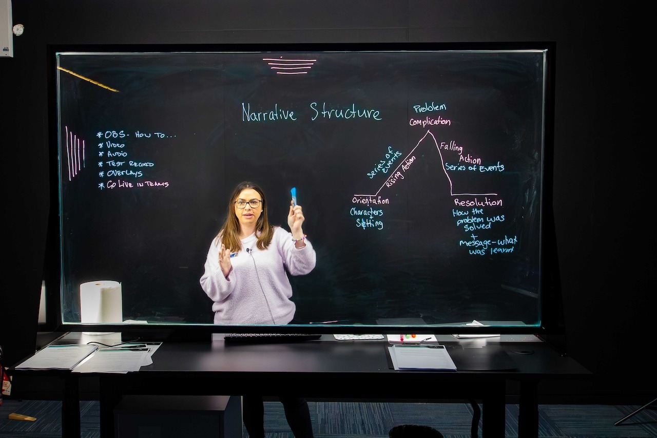 Teacher recording a lesson in the Lightboard Studio